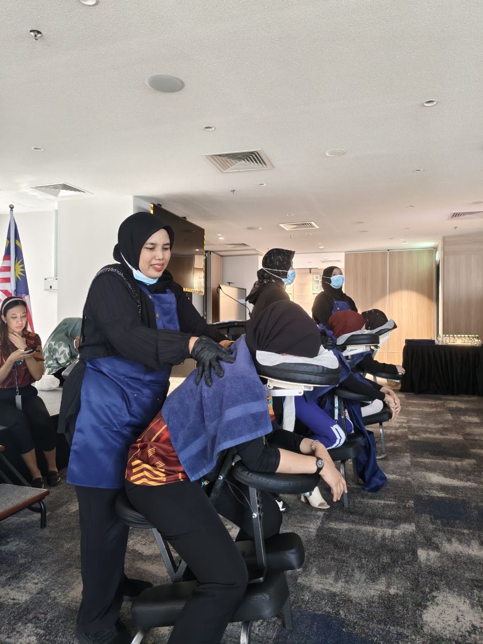 Therapist providing corporate massage